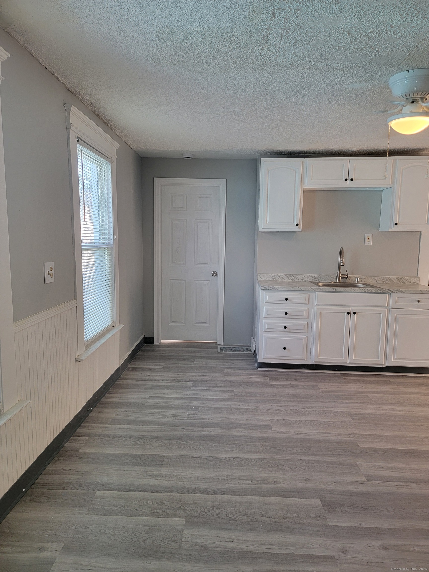 322 Bassett Street, Unit 2 New Haven, CT 06511 - Photo 8 of 14 a view of a kitchen with wooden floor and cabinets