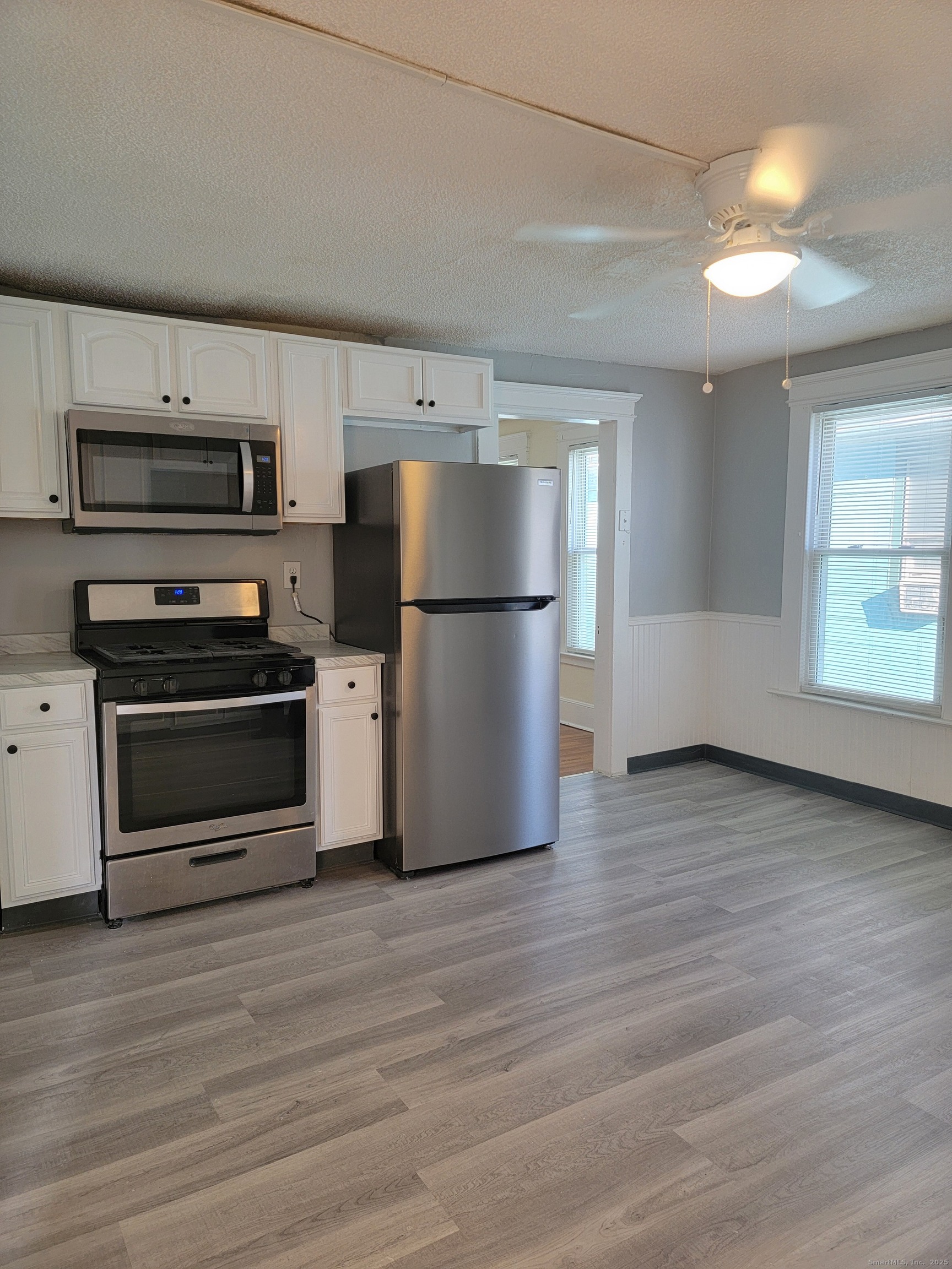 322 Bassett Street, Unit 2 New Haven, CT 06511 - Photo 9 of 14 a kitchen with stainless steel appliances a refrigerator and a stove top oven