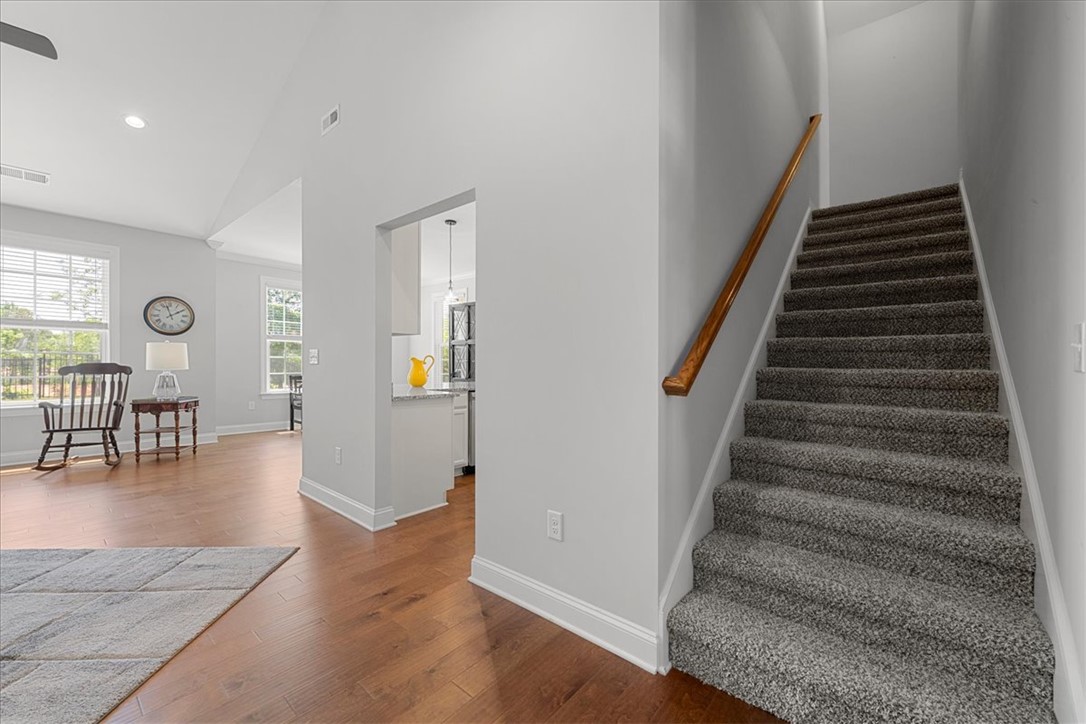 21 Barron Glenn Way Anderson, SC 29621 - Photo 16 of 48 This inviting home showcases a graceful staircase and rich hardwood flooring, creating a warm, appealing interior.
