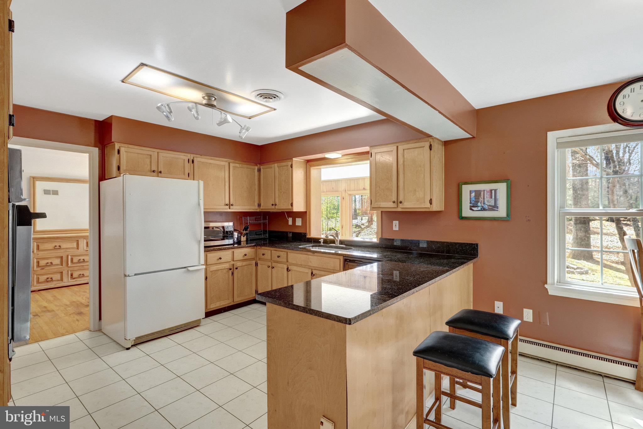 11332 Vale Road Oakton, VA 22124 - Photo 20 of 52 a kitchen with granite countertop a refrigerator stove top oven and sink