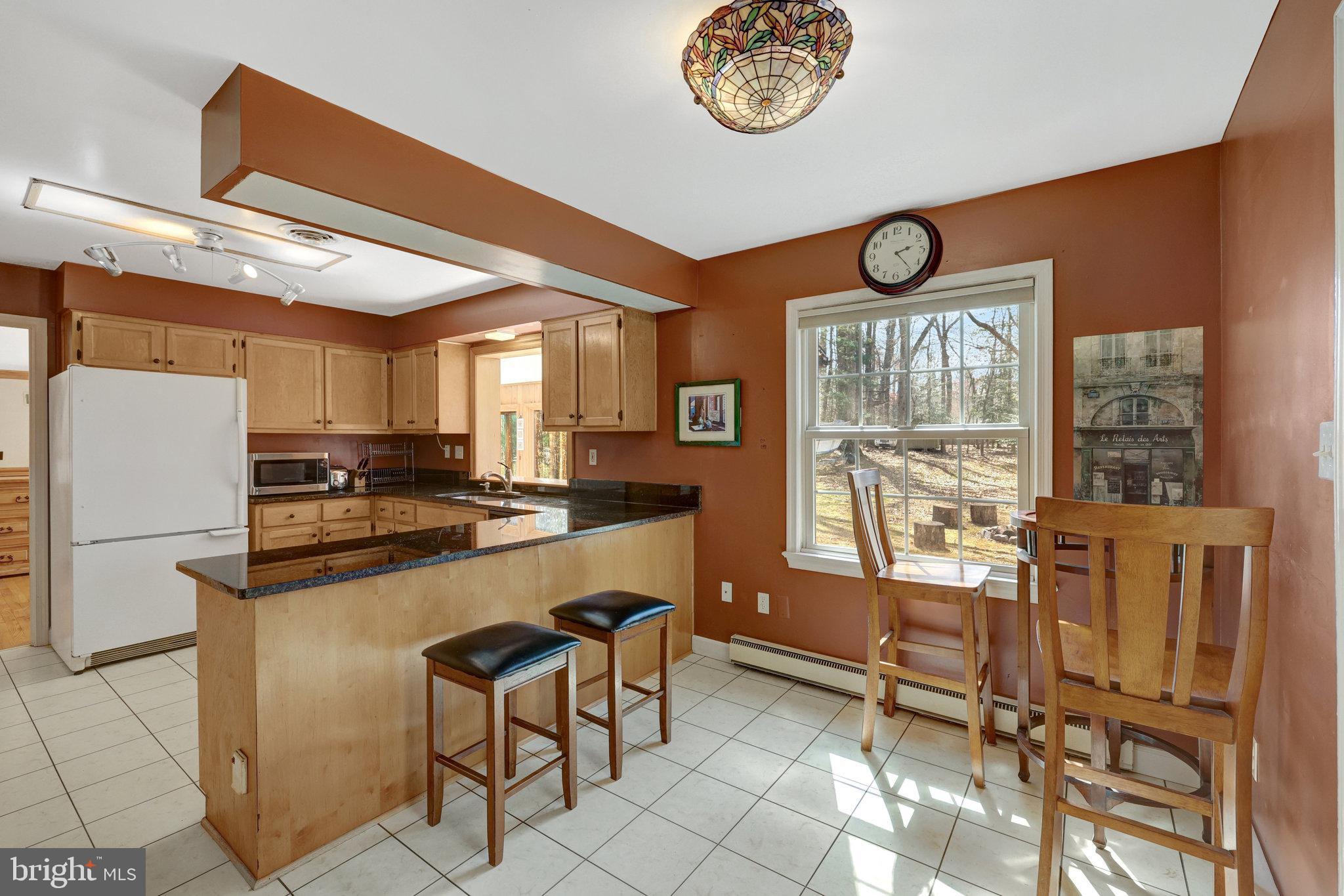 11332 Vale Road Oakton, VA 22124 - Photo 25 of 52 a kitchen with stainless steel appliances granite countertop a stove a refrigerator and a dining table with the kitchen view