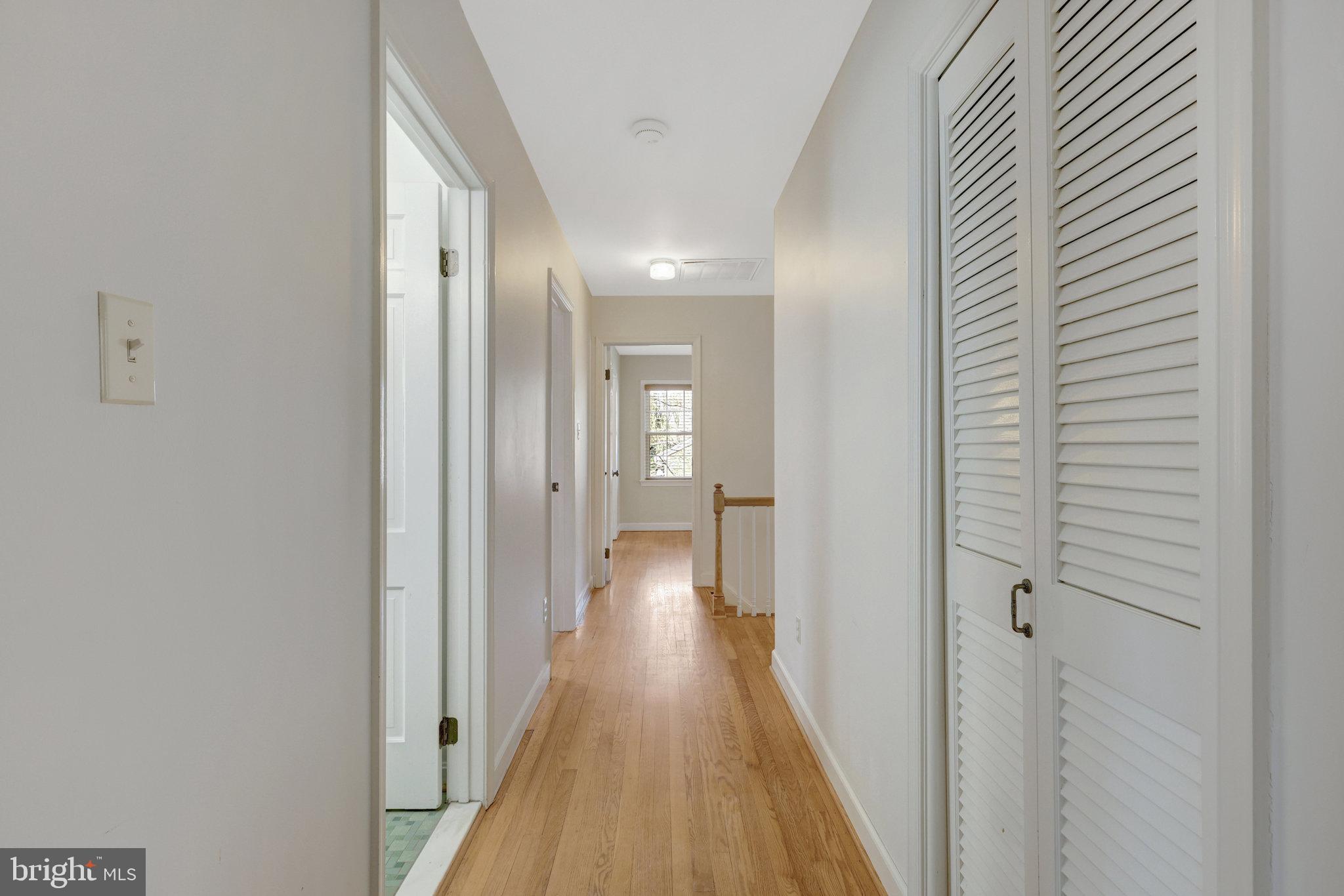 11332 Vale Road Oakton, VA 22124 - Photo 26 of 52 a view of a hallway with wooden floor