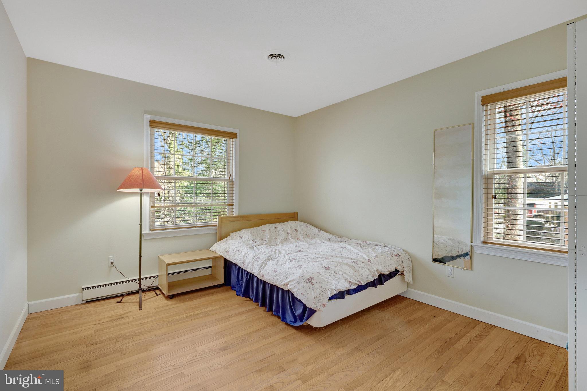 11332 Vale Road Oakton, VA 22124 - Photo 27 of 52 a spacious bedroom with a bed and a window