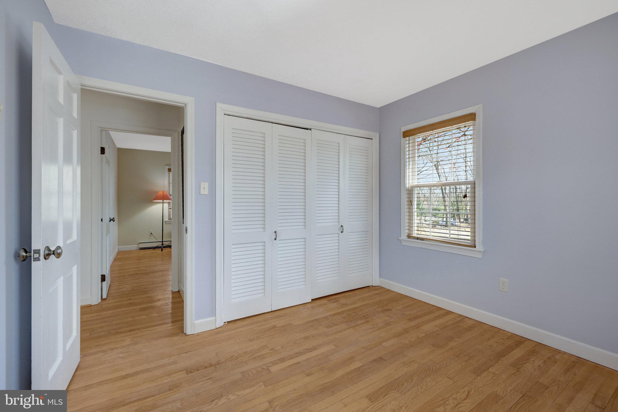 11332 Vale Road Oakton, VA 22124 - Photo 29 of 52 an empty room with wooden floor closet and windows