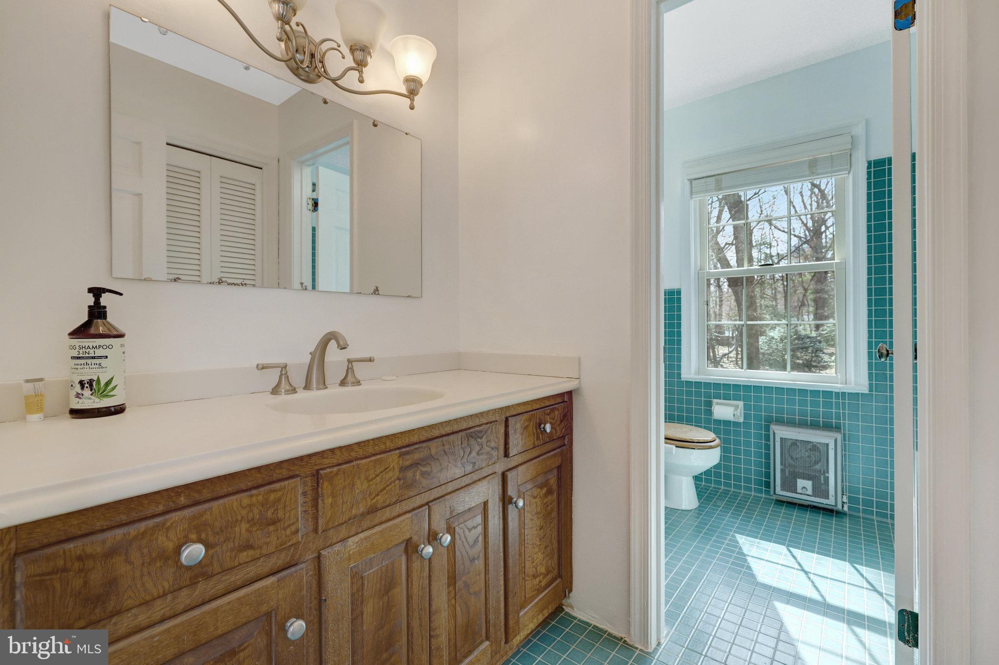 11332 Vale Road Oakton, VA 22124 - Photo 37 of 52 a bathroom with a granite countertop sink mirror and a toilet