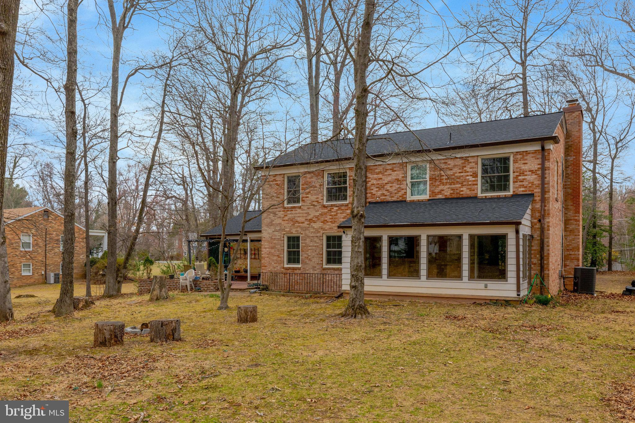 11332 Vale Road Oakton, VA 22124 - Photo 46 of 52 a backyard of a house with large trees and barbeque oven