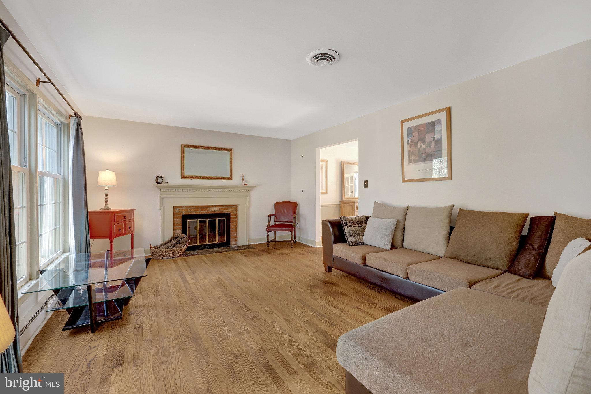 11332 Vale Road Oakton, VA 22124 - Photo 7 of 52 a living room with furniture and a fireplace