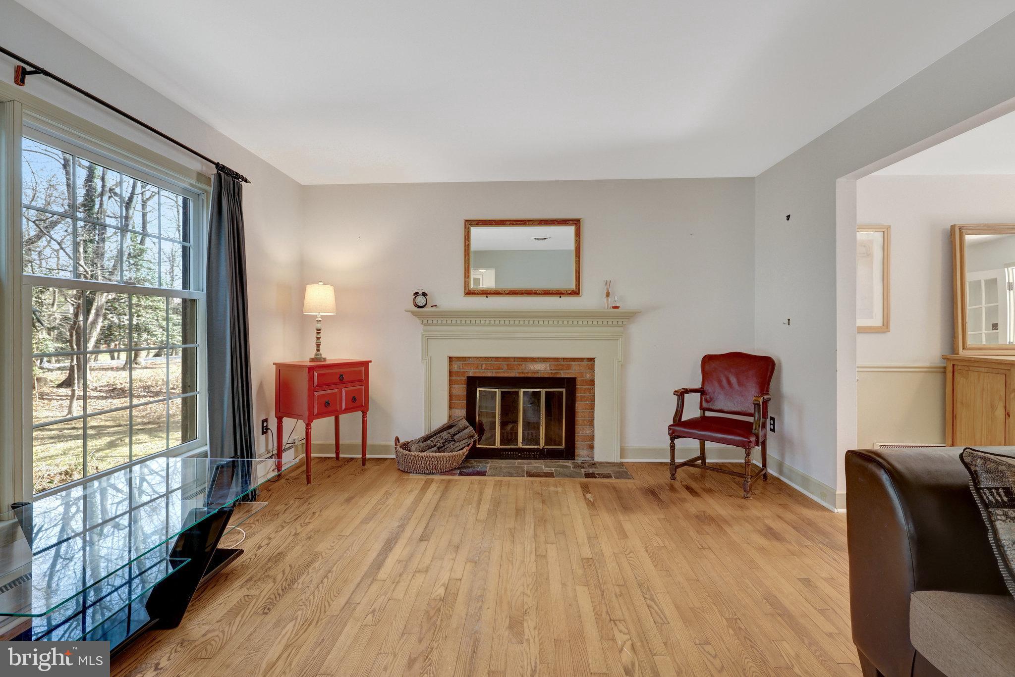 11332 Vale Road Oakton, VA 22124 - Photo 10 of 52 a living room with furniture and a fireplace