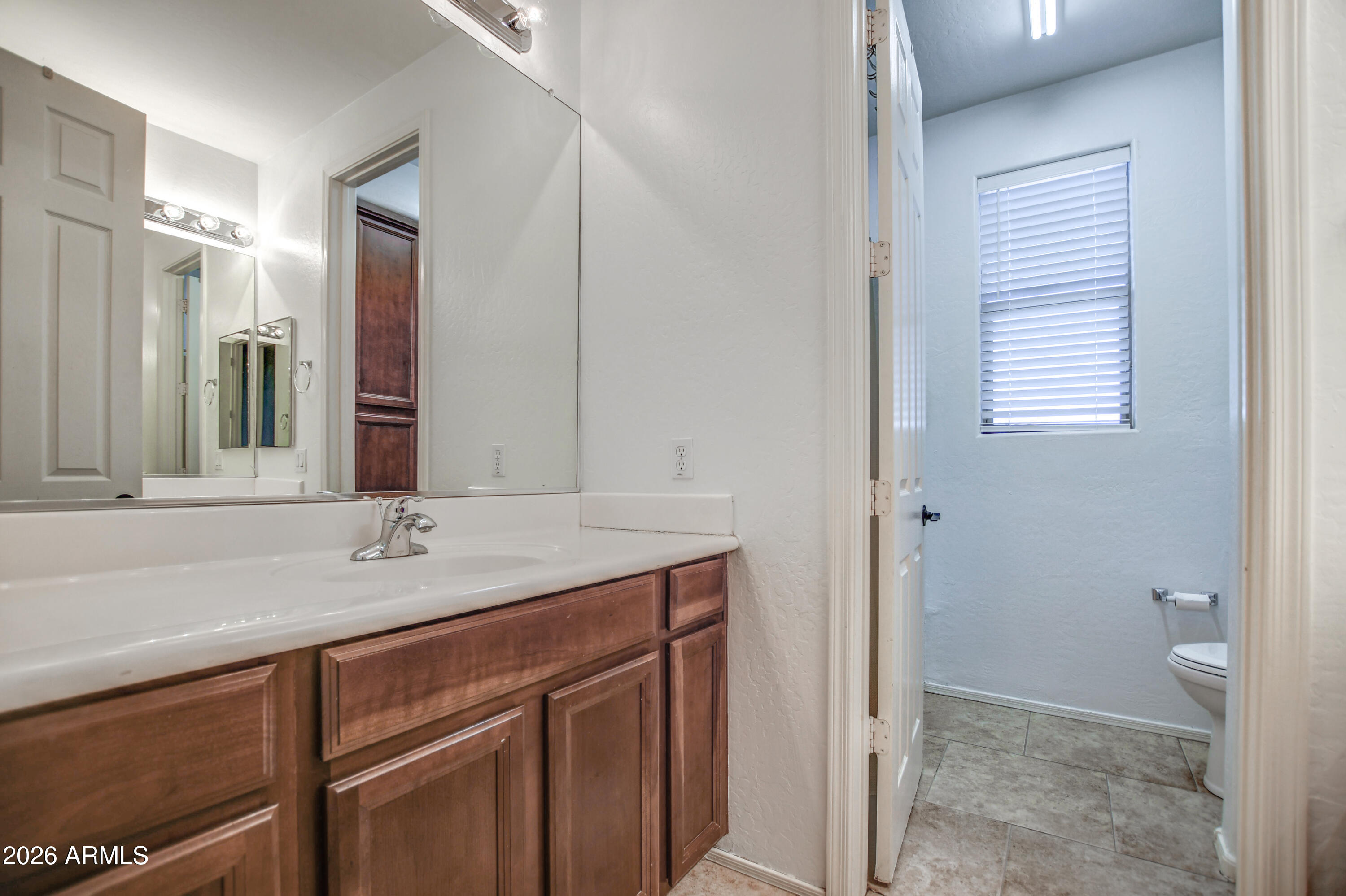 3078 East Muirfield Street Gilbert, AZ 85298 - Photo 75 of 92 a bathroom with a sink and a mirror