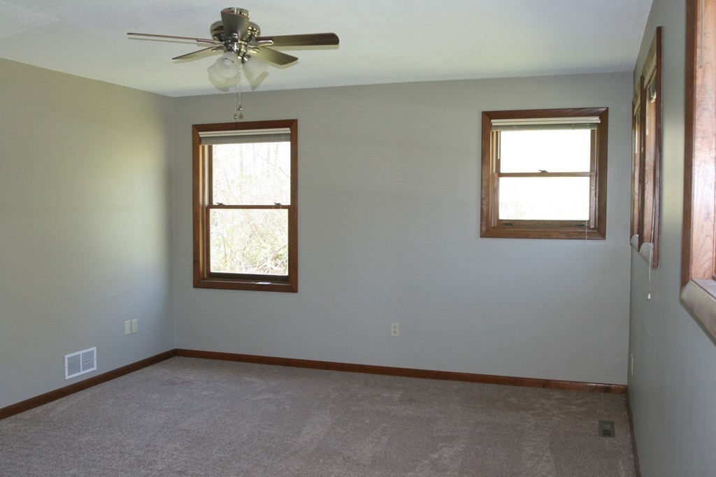 100 Signal Hill Circle Springfield, MA 01118 - Photo 13 of 19 an empty room with windows and fan