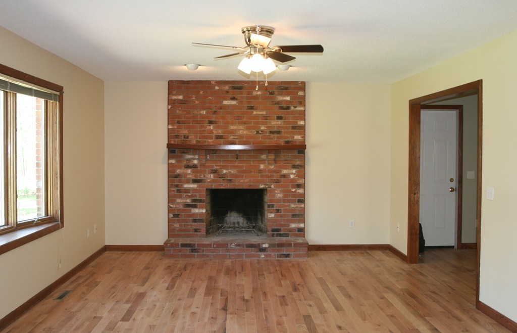 100 Signal Hill Circle Springfield, MA 01118 - Photo 2 of 19 a view of empty room with wooden floor and a fireplace