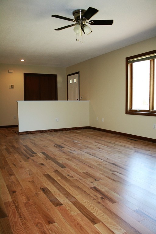 100 Signal Hill Circle Springfield, MA 01118 - Photo 3 of 19 an empty room with wooden floor and windows