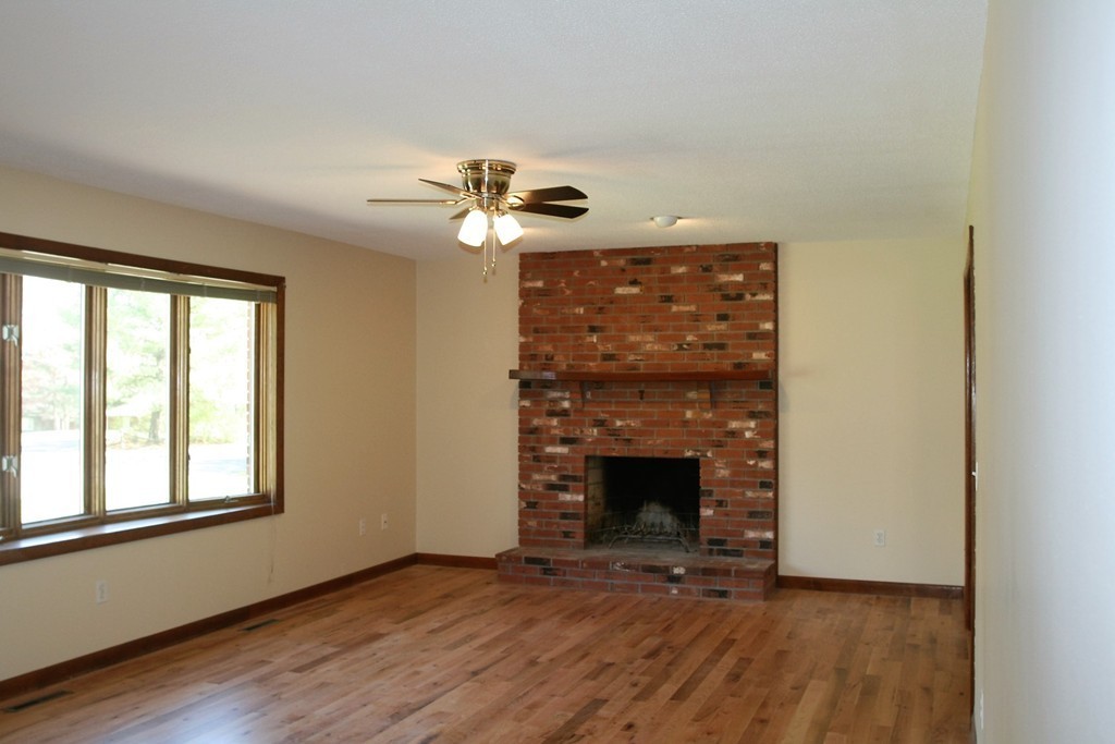 100 Signal Hill Circle Springfield, MA 01118 - Photo 4 of 19 a view of an empty room with a fireplace and a window