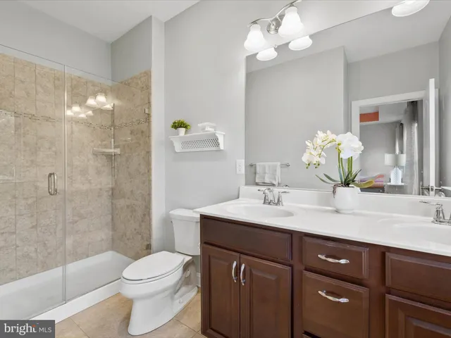 an empty room with a window and a ceiling fan