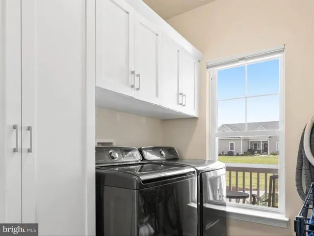 a view of a chair and tables in the back yard of the house