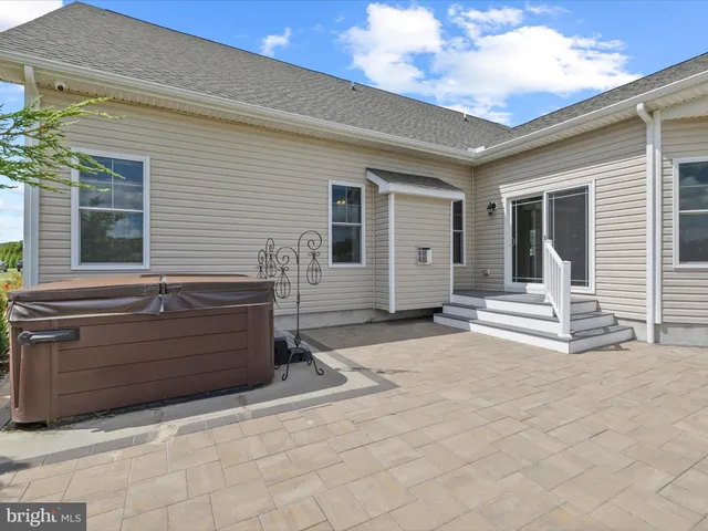 a view of a house with swimming pool and sitting area