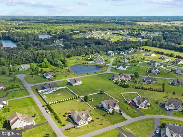 an aerial view of a house with a yard basket ball court and outdoor seating