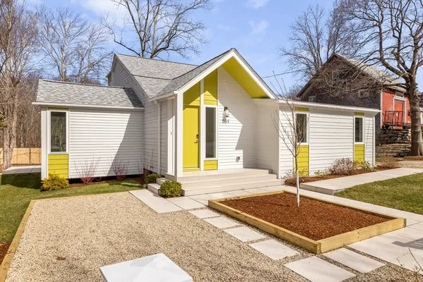 a front view of a house with garden
