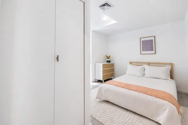 a bedroom with a bed and a chair