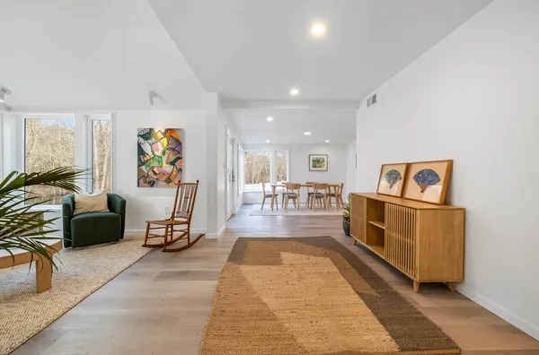 a living room with furniture and a potted plant
