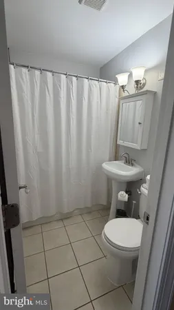 a white toilet sitting next to a bathroom sink