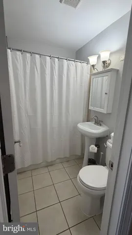 a white toilet sitting next to a bathroom sink