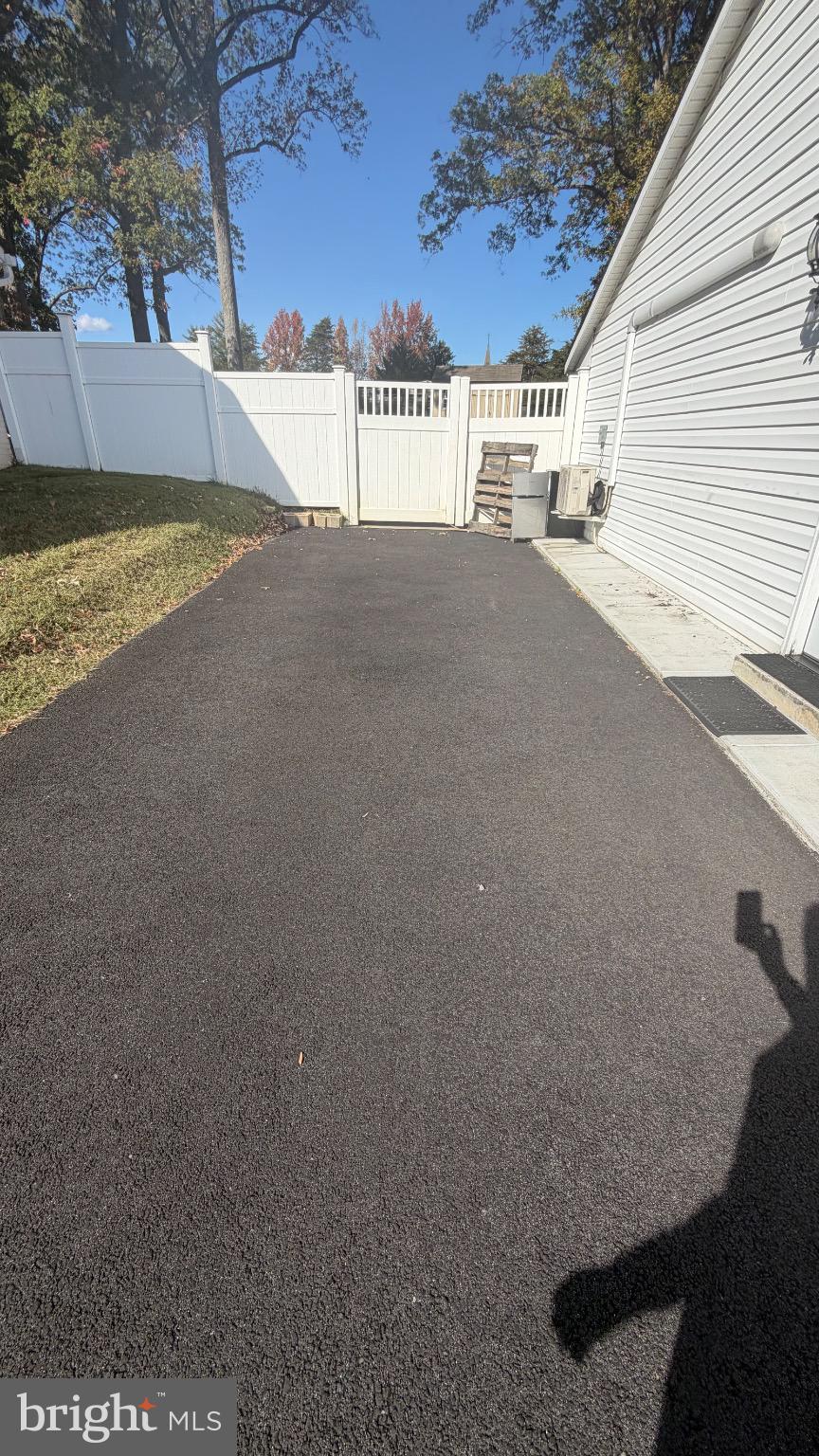 7306 Old Keene Mill Road Springfield, VA 22150 - Photo 20 of 21 a view of a house with a yard and garage