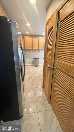 a view of a hallway to a kitchen