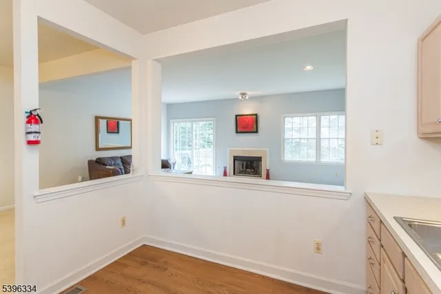a view of a kitchen with wooden floor and a window