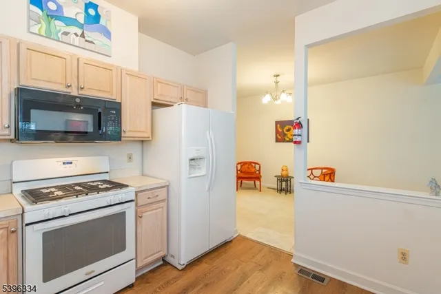 a kitchen with stainless steel appliances a stove a microwave and a refrigerator