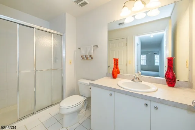 a bathroom with a sink vanity mirror and toilet