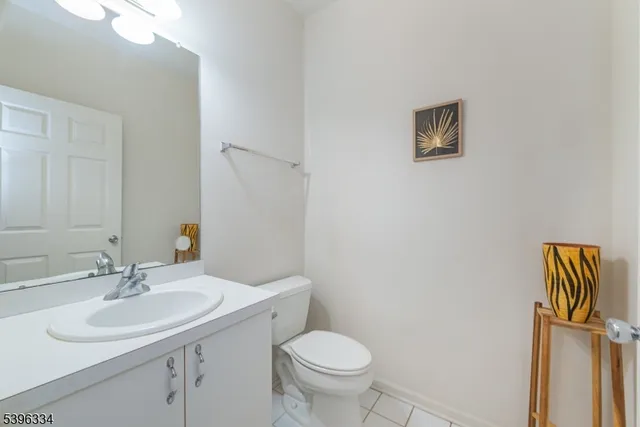 a bathroom with a sink toilet and a mirror