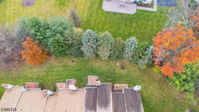 an aerial view of residential house with outdoor space and trees