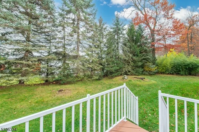 a view of a yard with wooden fence