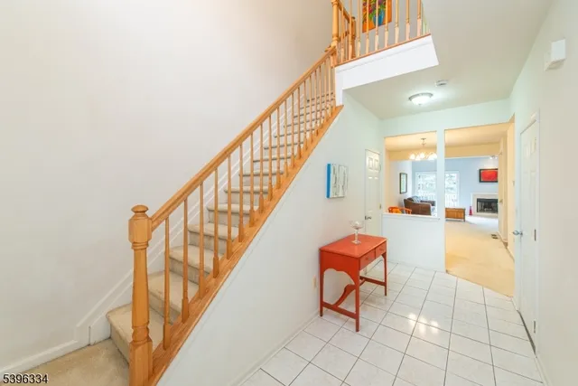 a view of staircase with furniture and a potted plant