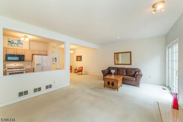a living room with furniture and large windows