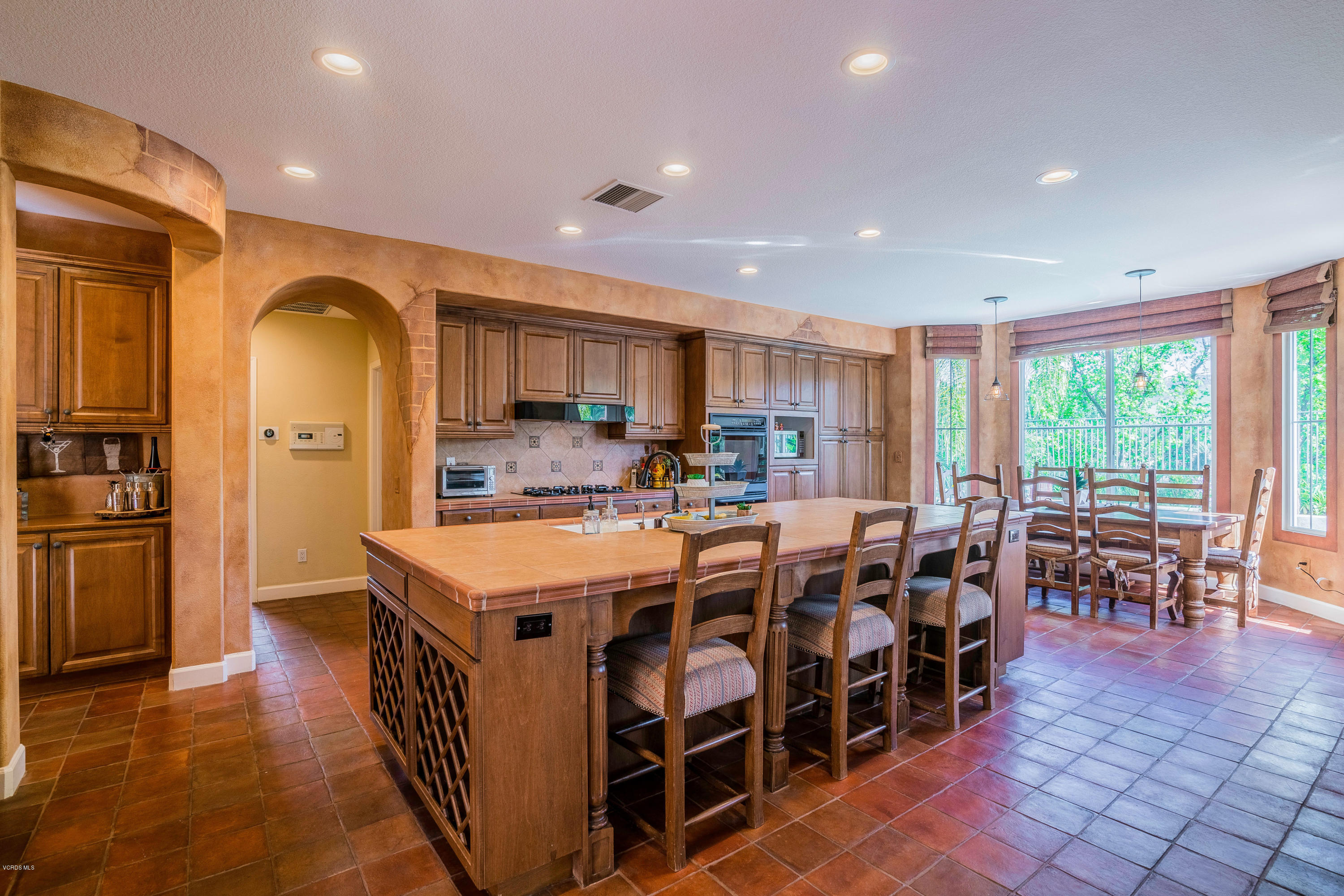 160 Laurel Ridge Drive Simi Valley, CA 93065 - Photo 14 of 45 a kitchen with lots of wooden furniture a sink a dining table and chairs