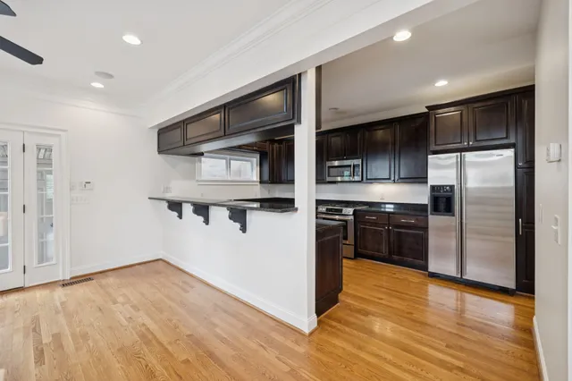 a kitchen with stainless steel appliances a refrigerator and a stove top oven