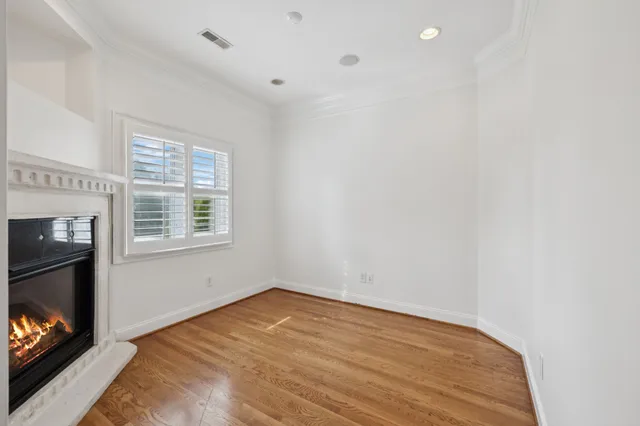 a view of empty room with window and fireplace