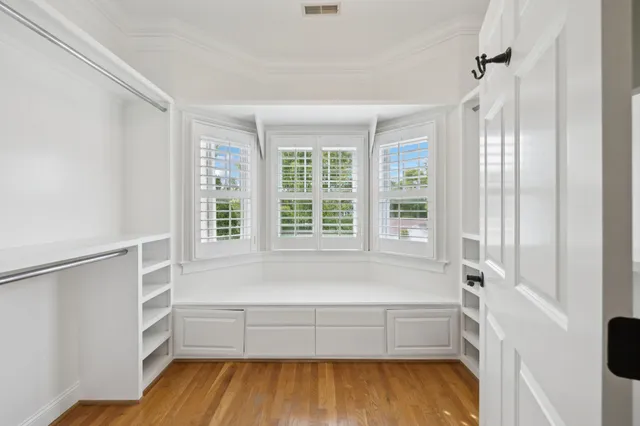 a view of a hallway with wooden floor and entryway