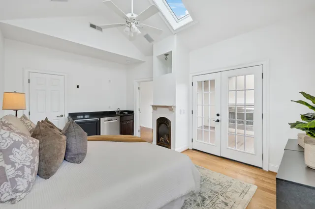 a bathroom with a granite countertop sink a mirror and shower