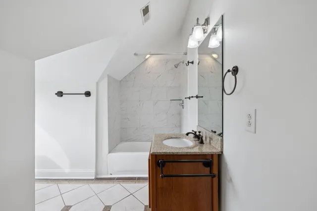 a bathroom with a sink mirror toilet and bathtub