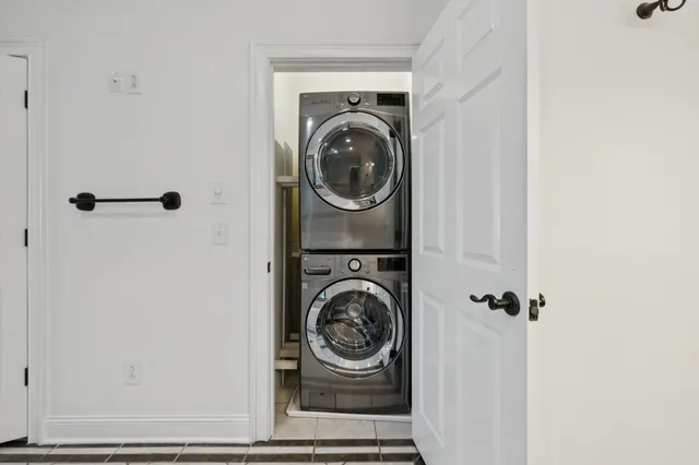 an empty room with windows and fireplace