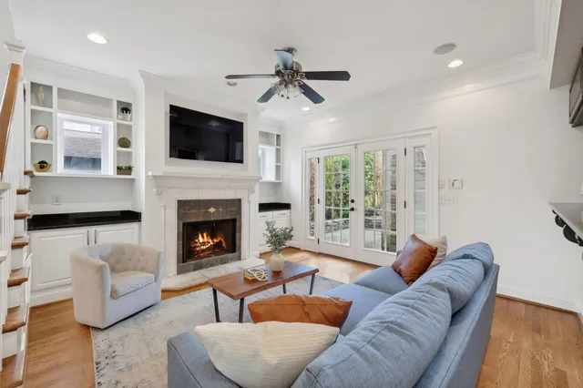 a living room with furniture a fireplace and a flat screen tv
