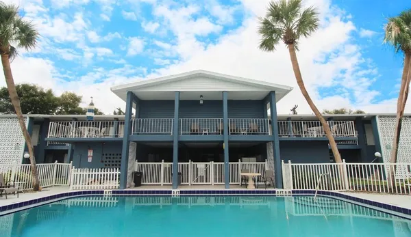 a view of house with swimming pool and sitting area