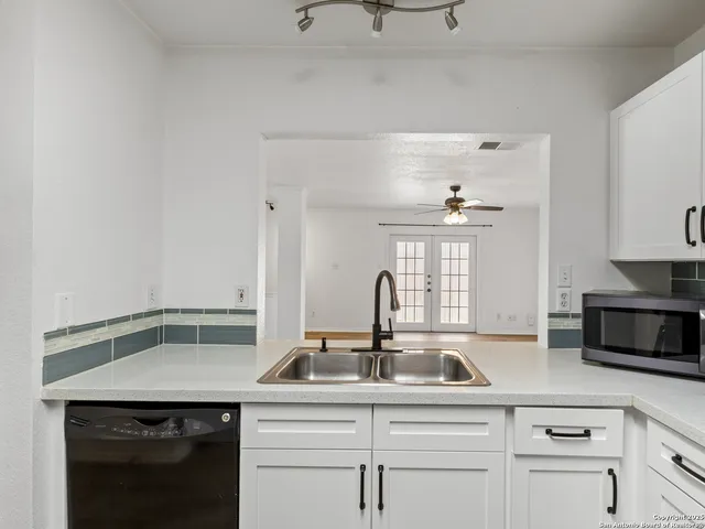 a kitchen with a sink and cabinets