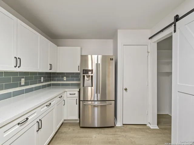 a kitchen with a refrigerator sink and microwave