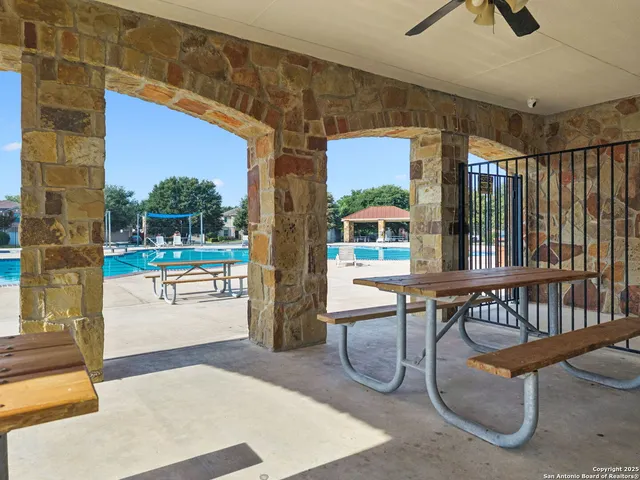 a view of a patio with table and chairs under an umbrella