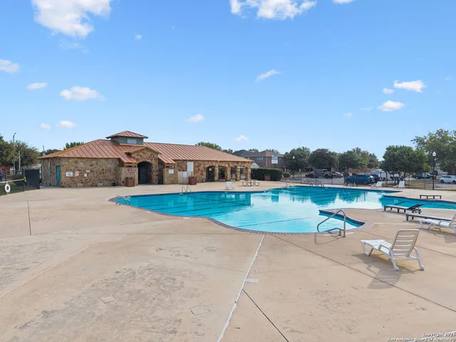 a view of a swimming pool with a yard