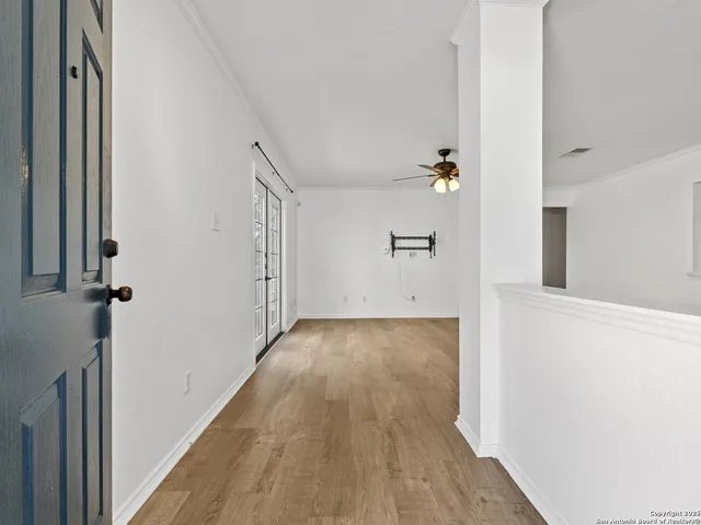 a view of a hallway with wooden floor